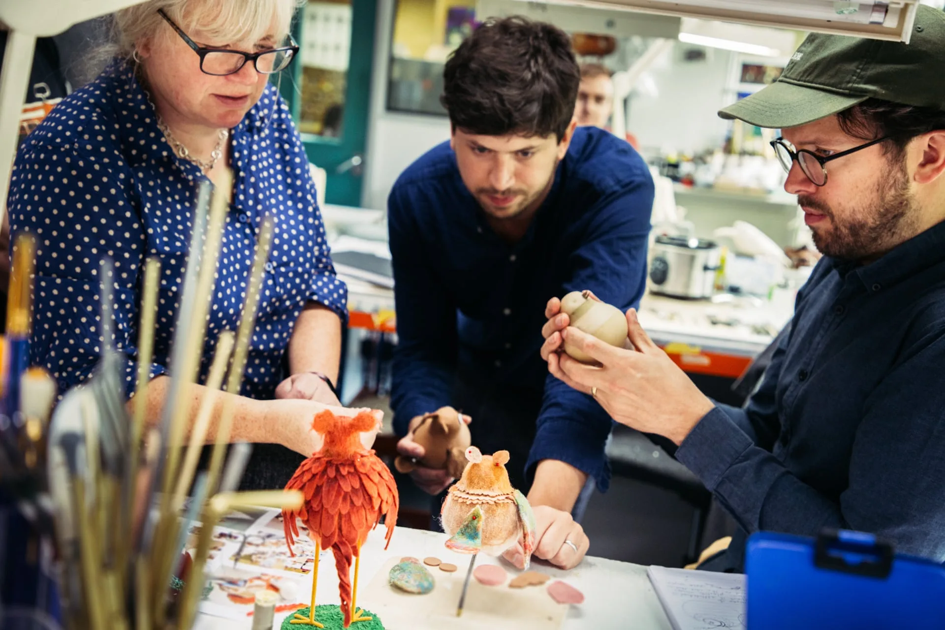 Aardman artists sculpting and painting puppets for Robin Robin
