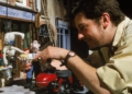 Loyd Price adjusts Wallace and Gromit beside the red motorbike on the Wendolene’s Wools set of A Close Shave.