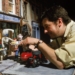 Loyd Price adjusts Wallace and Gromit beside the red motorbike on the Wendolene’s Wools set of A Close Shave.